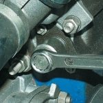Unscrewing the chain tensioner cap nut